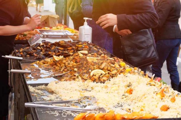 Mussels, shrimp and other seafood on street market, takeaway. Fast or street food concept. Festival of fish and seafood Cuisine.