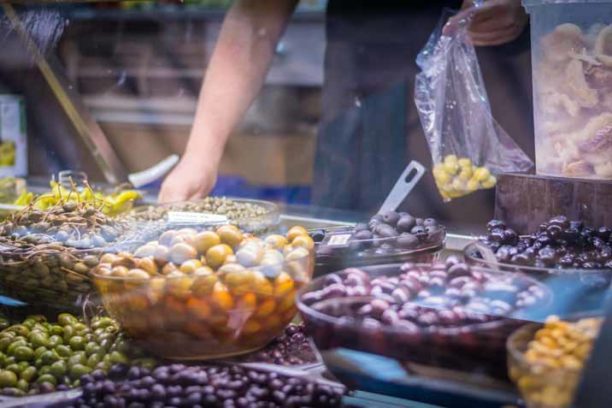 Man packing olives in a market in Valencia, Spain