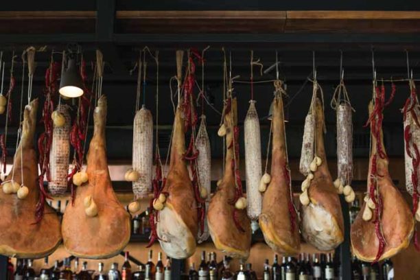 Dry and salty jamon legs hanging on a bar counter