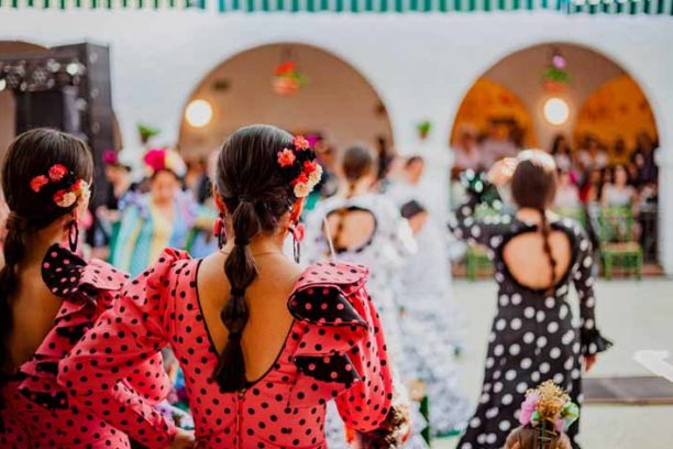 spanish woman dressed as sevillian at a traditional festival in